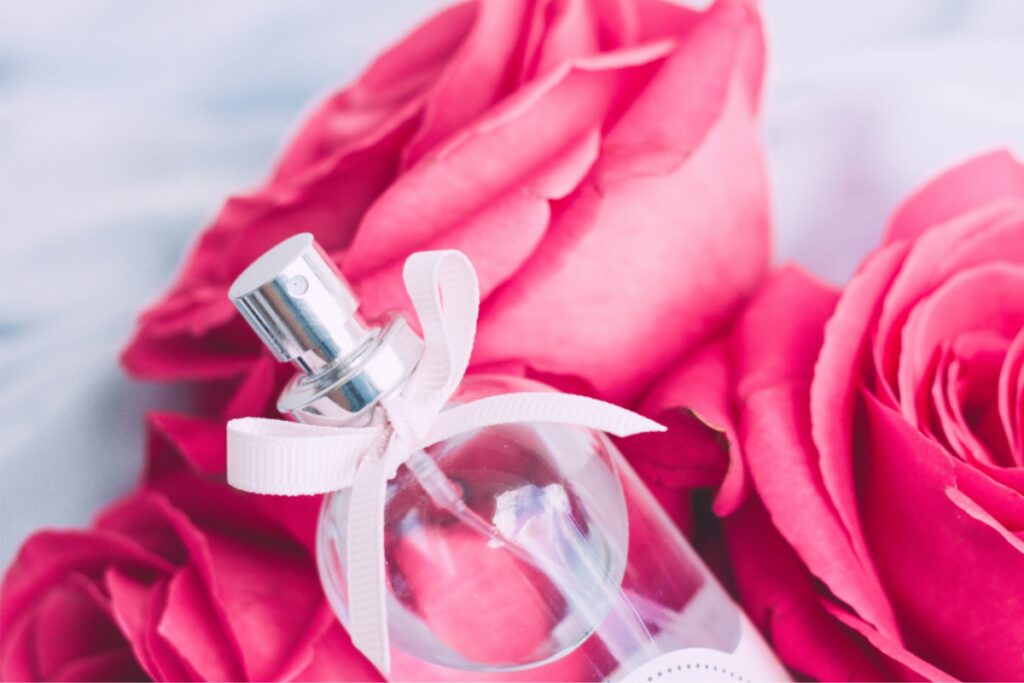 women perfume with pink roses